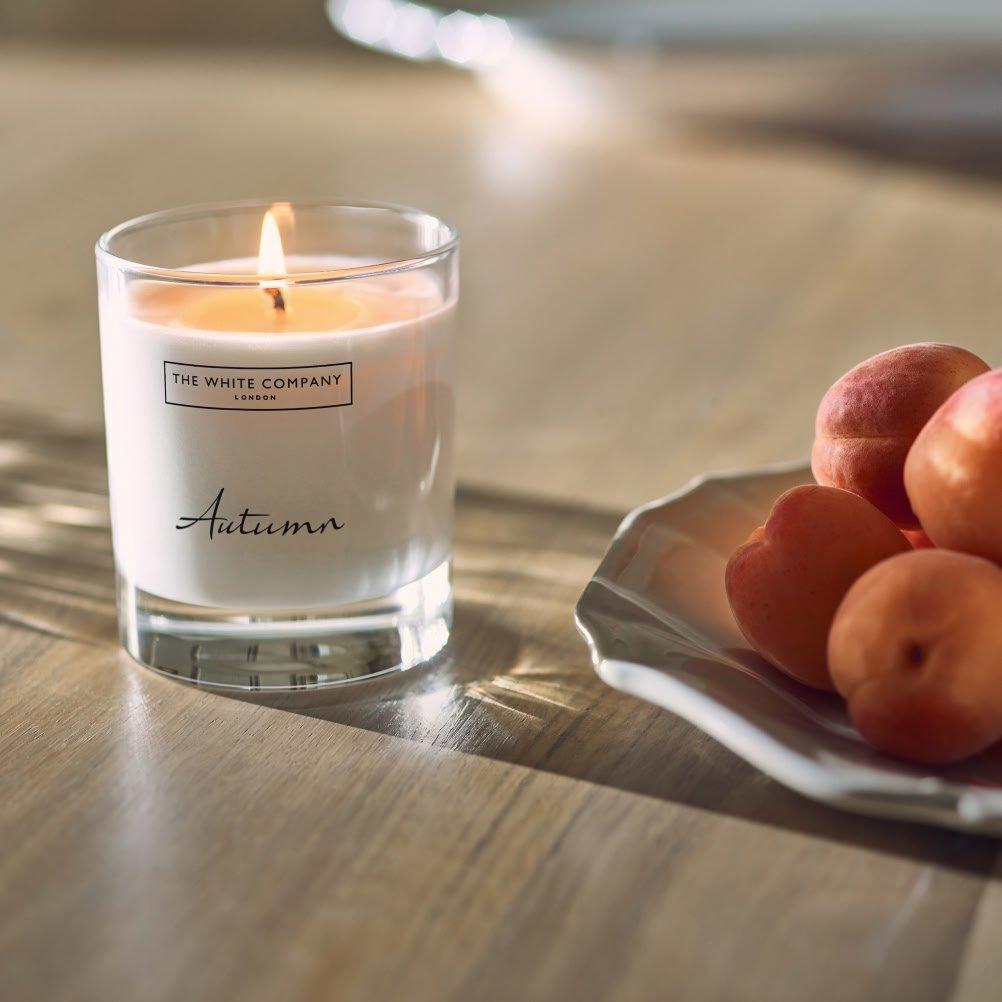 a plate of fruit and a candle on a table