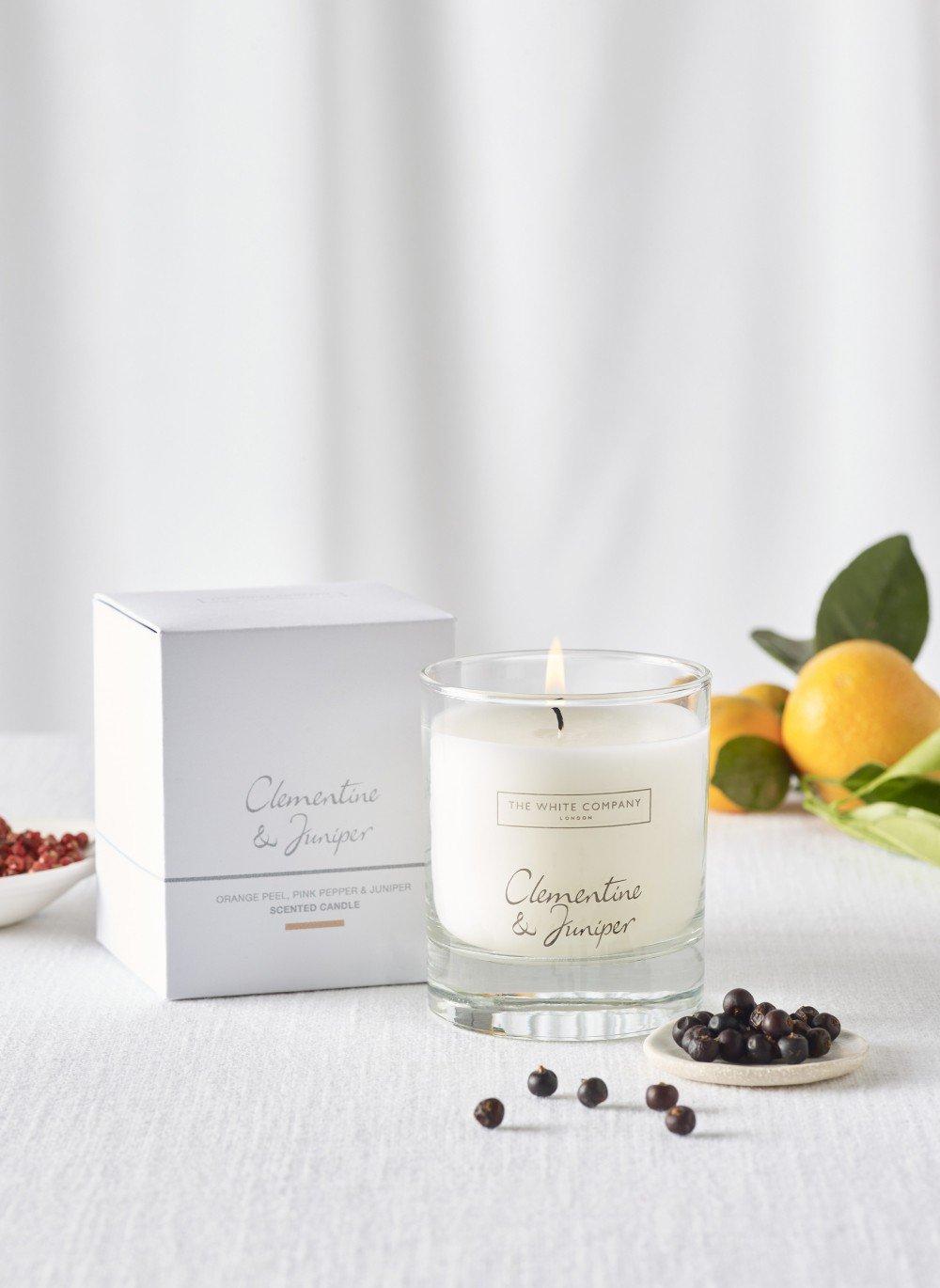 a candle and some fruit on a table next to a box