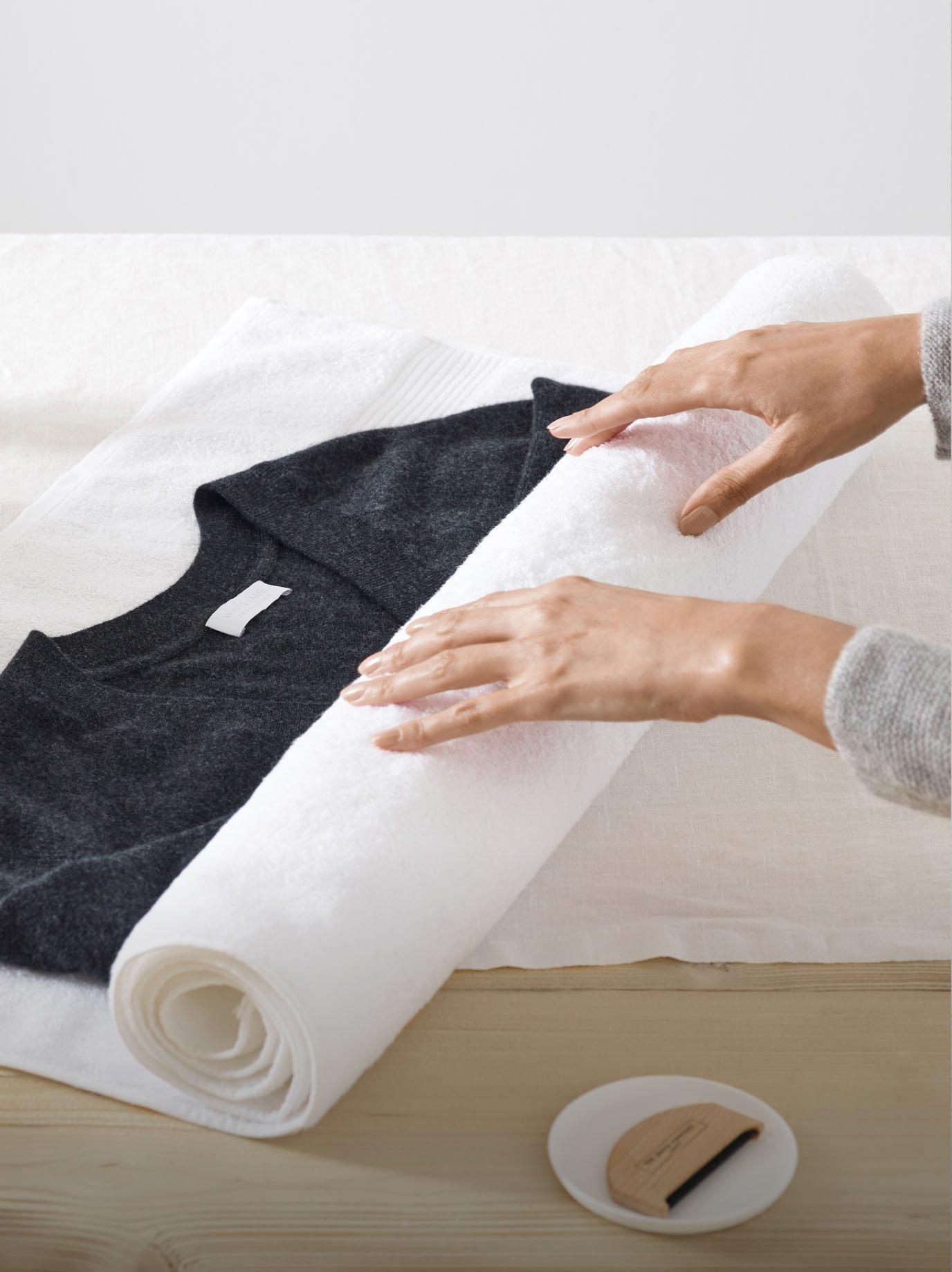 woman rolling jumper in paper