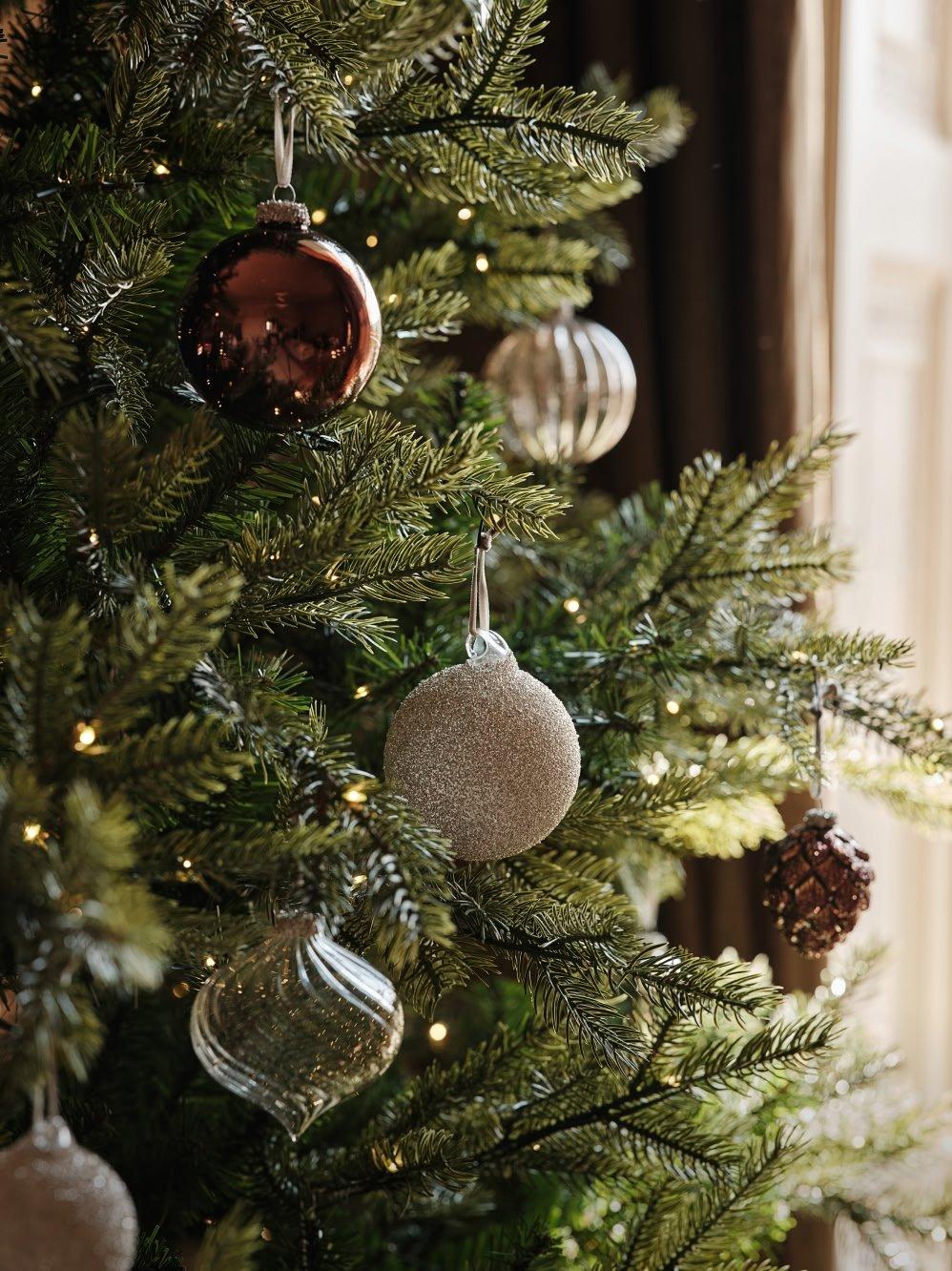 a close up of a christmas tree with ornaments on it
