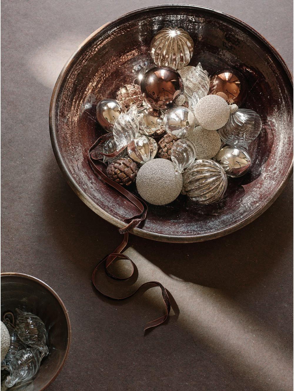 a bowl of ornaments on a table with a yellow string