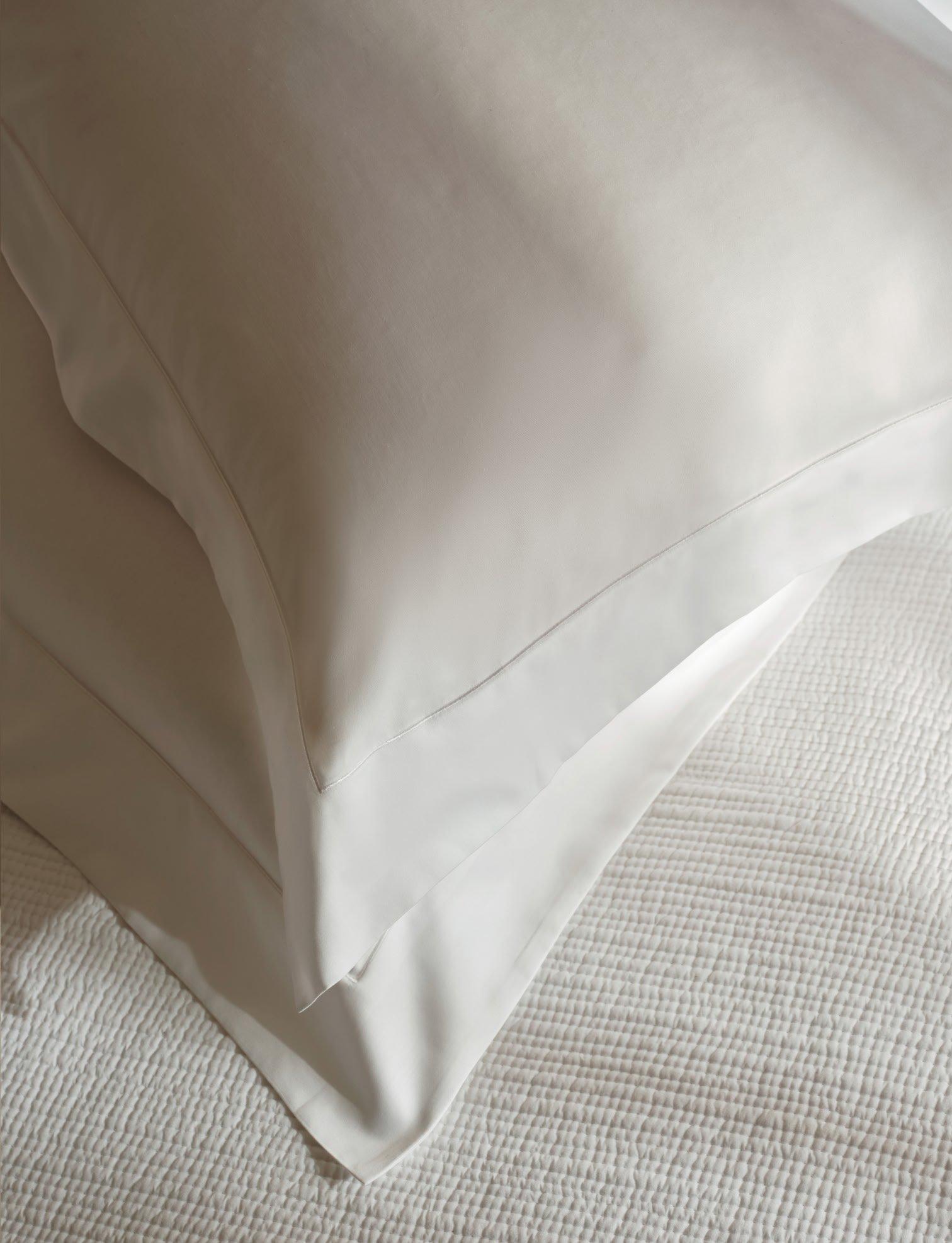 white pillows on a white bed
