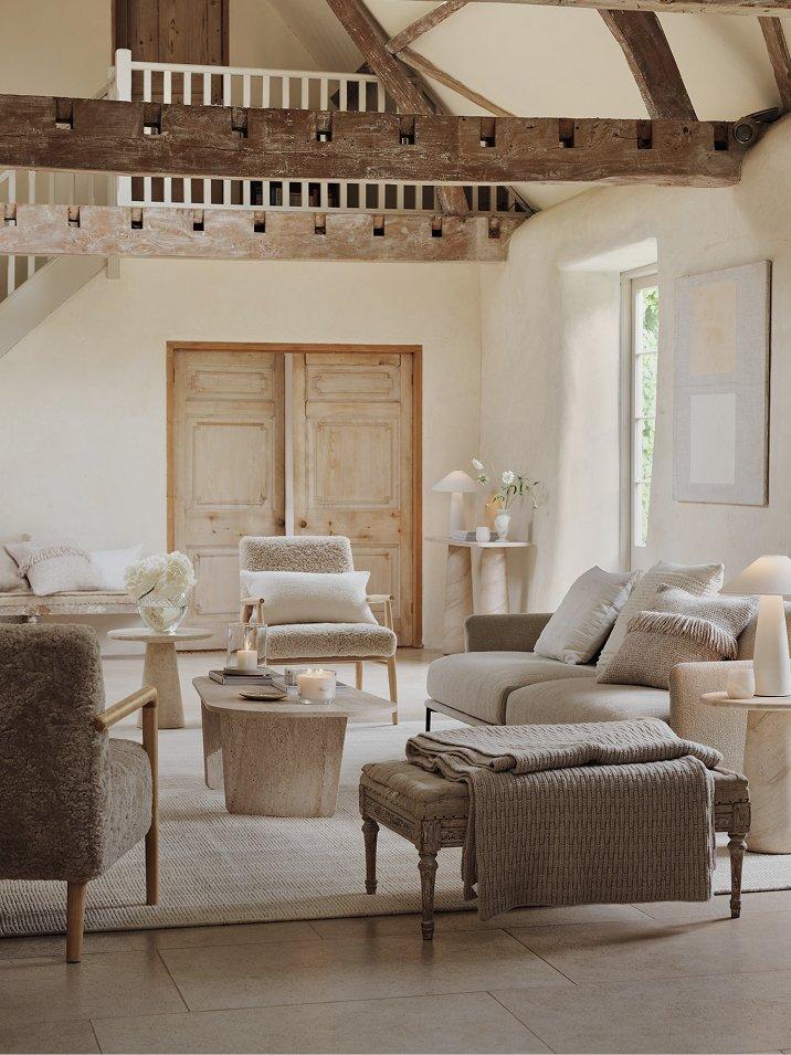 a living room with a fireplace and a large wooden beam