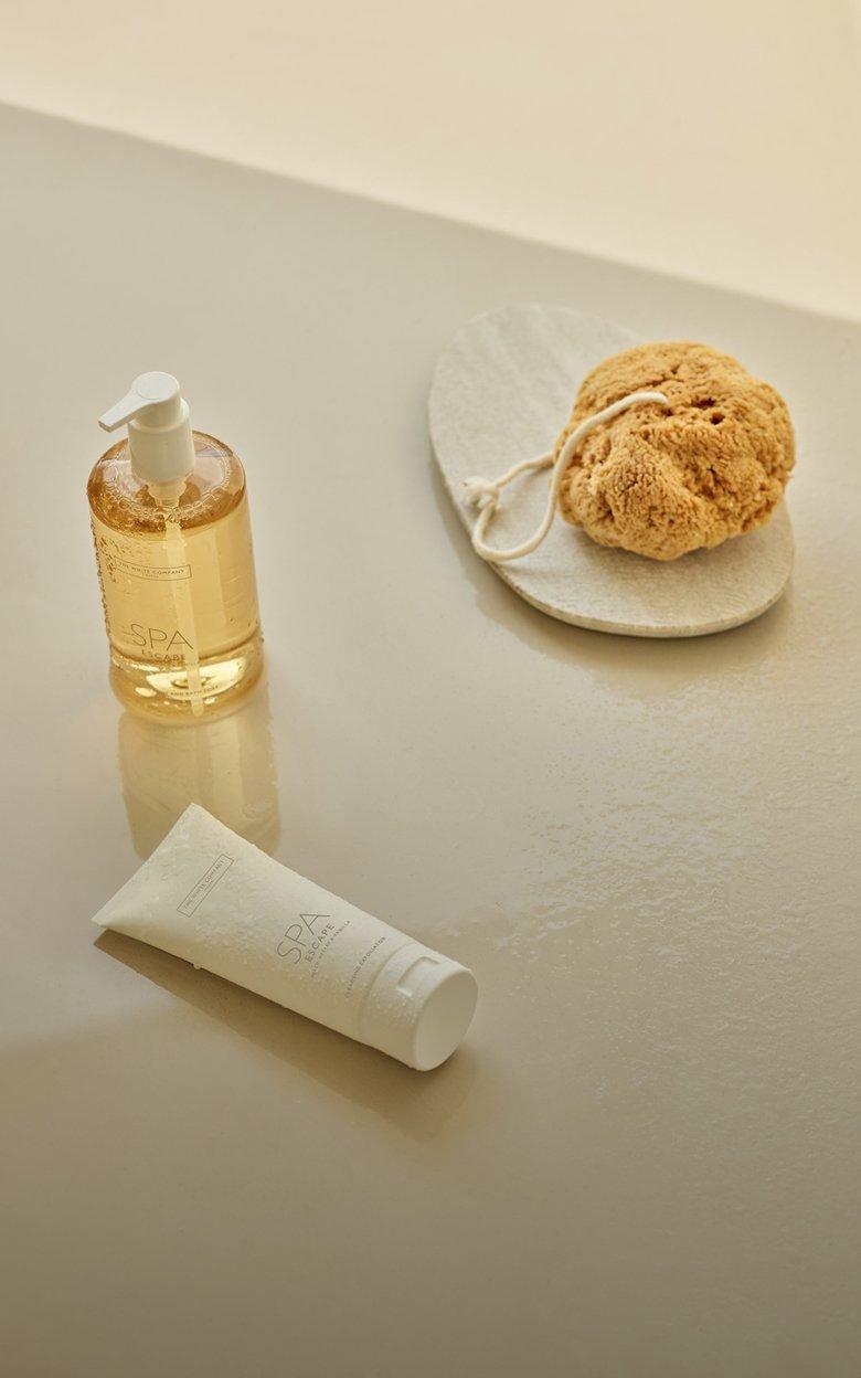 a bath products are on a counter next to a sponge