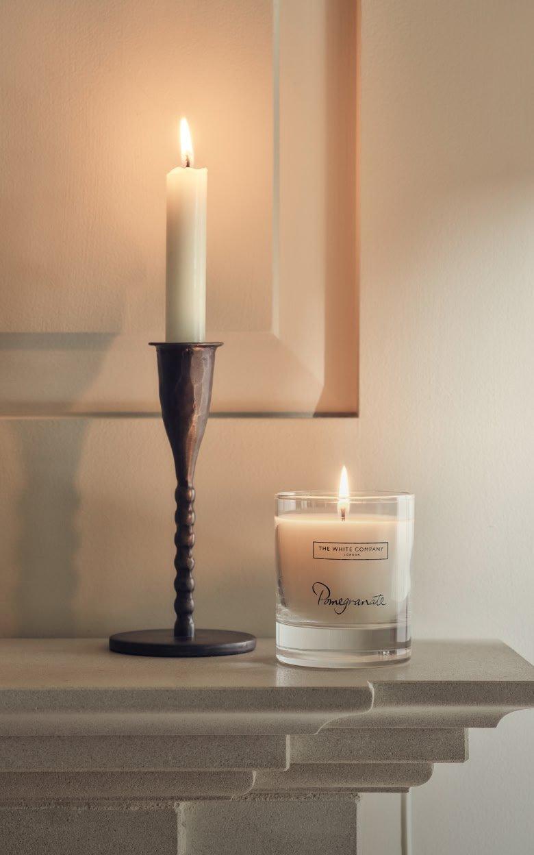 a candle and a candle holder on a mantle